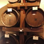 Stacked wooden barrels in a winery cellar for aging wine, showcasing traditional storage methods.