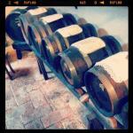 Wooden wine barrels aging in a rustic cellar. Cozy setting for traditional wine production.